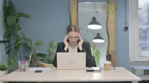 Stressed Young Woman Working at Her Desk