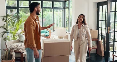 Couple Moving Boxes into New Home Together