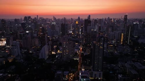 Vibrant city skyline illuminated at sunset captured from high above