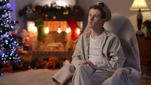 Man Crying in Rocking Chair at Christmas