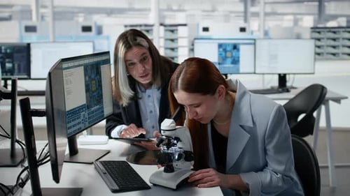 Reviewing Semiconductor Substrate Structures Microscope and Woman in Office