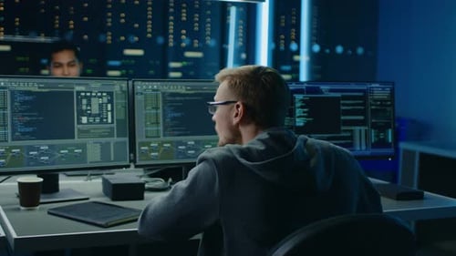IT Specialist Working on Personal Computer with Monitors Showing Coding Language Program, He Celebr