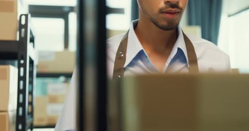 man wear formal shirt hold digital tablet check inventory online stock data in cardboard box.