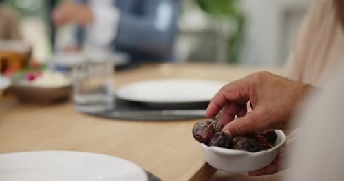 Sharing dates, food or hands of family in home with lunch, plate or celebration in social gathering