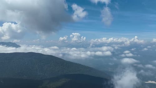 Aerial View of Green Mountain Partially Covered by Clouds