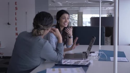 Businesswomen Discussing Ideas in Modern Office