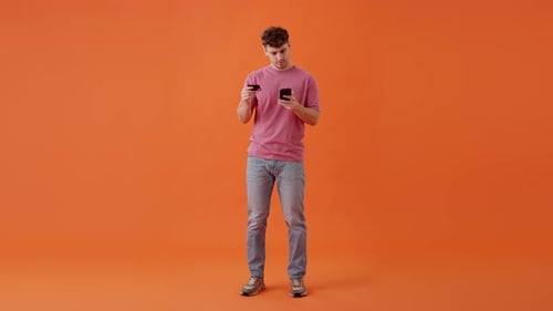 Young Man Online Shopping With Phone and Card