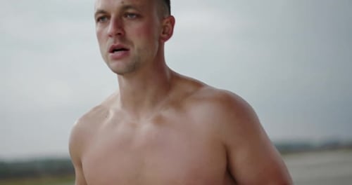 Shirtless Man Running Toward Camera