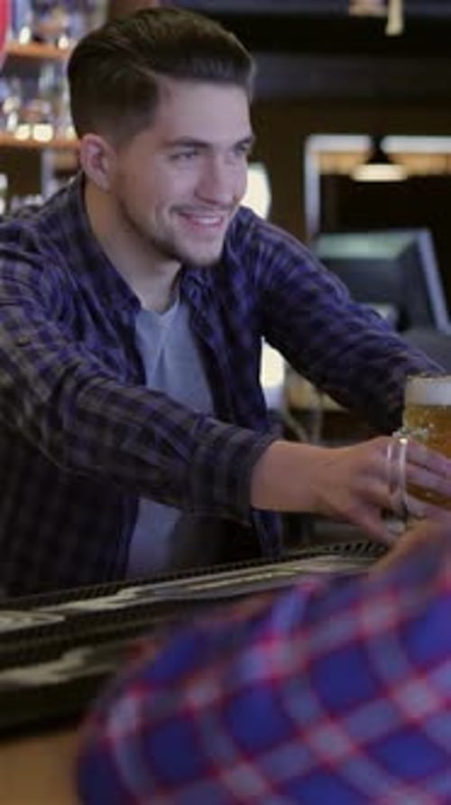 Friends Enjoying Beers at the Pub Counter