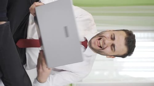 Man Celebrates Good News on Laptop