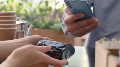 Pay by Phone on Pos Terminal at Coffee Bar. E-Money Transfer From