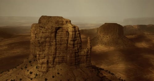 Vast Desert Landscape Features Majestic Rock Formations and Golden Hues