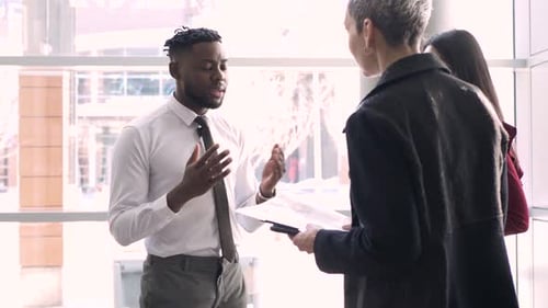 Business people meeting face to face in office lobby during daytime
