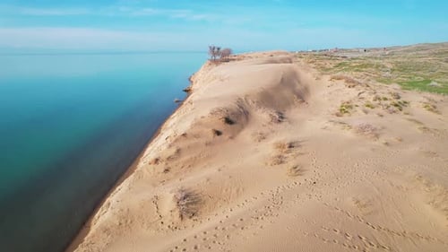 Desert Dune with Blue Sea at Sunrise