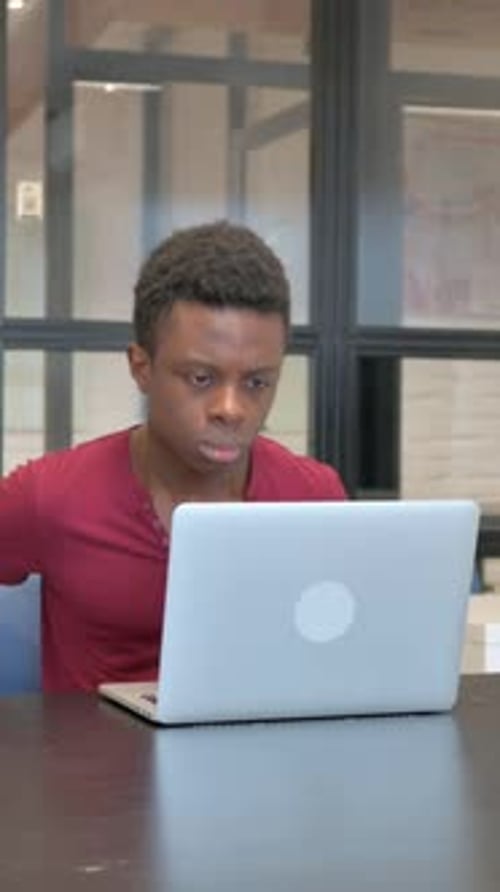 vertical video of Casual African Man Leaving Office after Working on Laptop