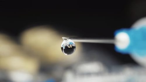 Close Up of Drop Suspended from Hypodermic Needle