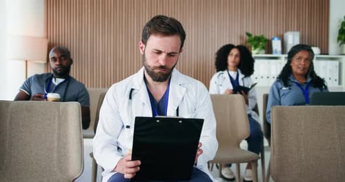 Doctor, team and clipboard at meeting, listen and coffee with notes for workshop at hospital