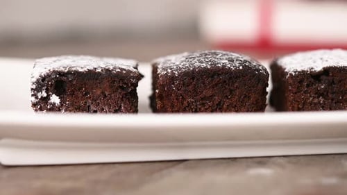 Powdered Sugar on Chocolate Brownie Squares on Platter