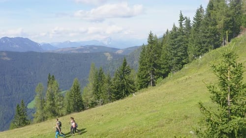 People Hiking in Mountains on a Sunny Day