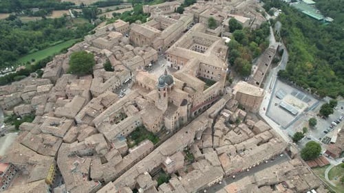 Top-down aerial view of the Palazzo Ducale di Urbino and surrounding historic buildings. The footage