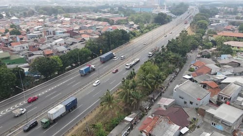 Aerial view of toll road that surrounded by residential area in Cakung, East Jakarta, Indonesia