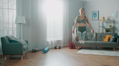 Woman Skipping Rope Indoors in a Bright Living Room