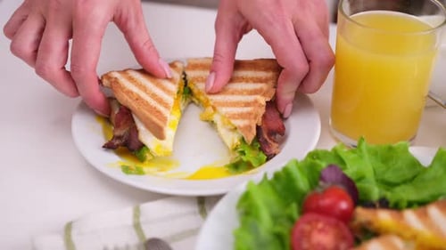 Breakfast Sandwich with Egg and Bacon Cut in Half