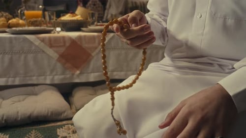 Young Muslim Man Praying Salat and Counting Beads on Eid al-Fitr