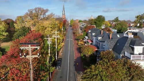 Rising aerial of historic American town in autumn. Colorful autumn fall foliage and tree leaves.
