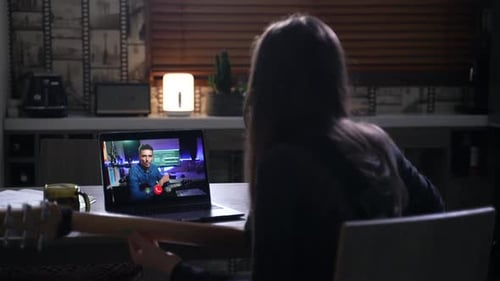 Woman Taking Guitar Lesson Online at Home