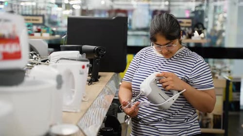 Indian Woman Chooses a Mixer Blender in the Appliances Store