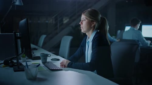 In the Office at Night Overworked Tired Female Office Worker Uses Desktop Computer In Despair Falls