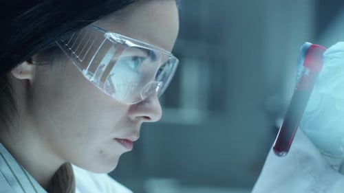 Woman Scientist Holding Test Tube of Blood Sample