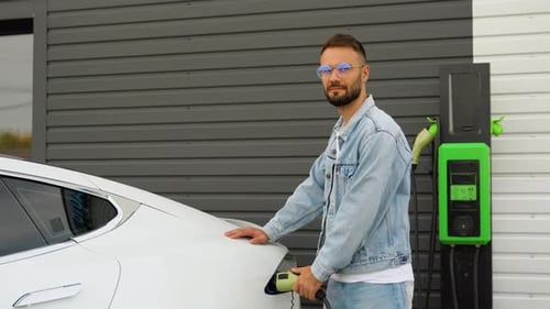 Man Charging Electric Car By the House Green Energy Eco Friendly Fuel