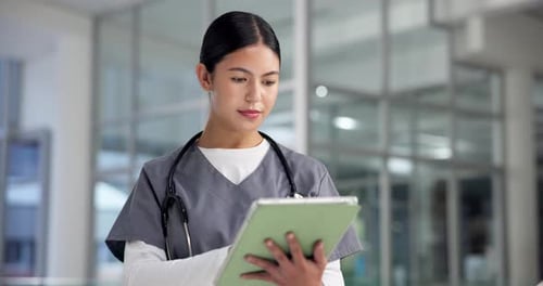 Woman, doctor and reading on tablet at hospital for research, medical report and schedule surgery