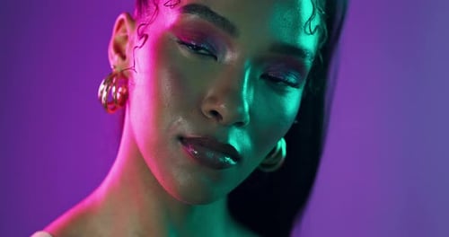 Neon lights, cosmetics and face of woman in studio with beauty, creativity and vibrant color