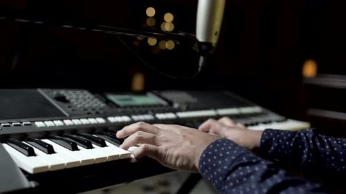 Man hands close up playing a piano for music lessons or performance in 4k