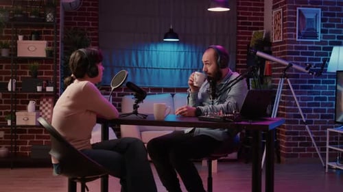 Online Radio Station Host Interviewing Guest in Late Night Talkshow Recording Podcast Using