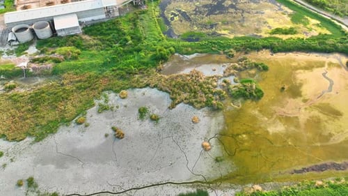 An aerial drone captures industrial wastewater flows into surface water.