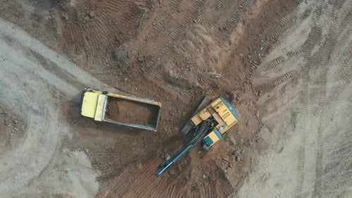 Excavator Loading Dirt in Rural Location Aerial