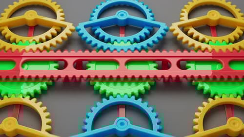 Looped animation of a group of multi-colored children plastic gears.