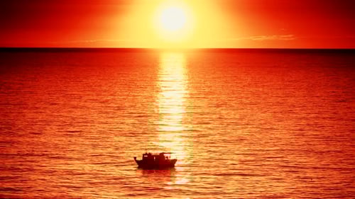 Fishing Boat on Sea at Sunrise