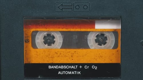 Orange Cassette Tape Spinning in a Player