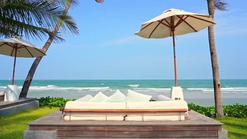 Luxury Beach Beds and Umrellas With Stunning View of Tropical Sea and Skyline on Sunny Summer Day Wi