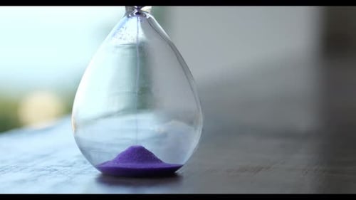 Closeup of Hourglass As Concept of Passing Time for Business Deadline Urgency and Outcome of Time