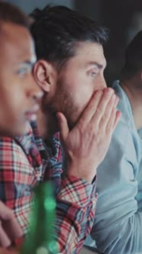 Excited men watch sports together