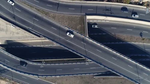 Aerial view of curvy interstate expressway with many vehicles at summer day