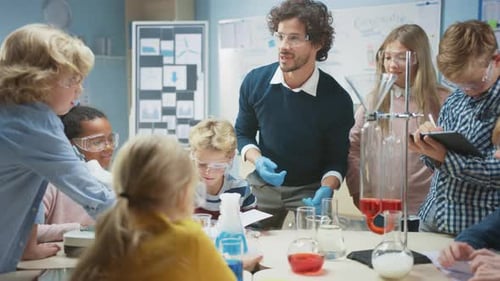 Elementary School Science Classroom: Enthusiastic Teacher Explains Chemistry to Diverse Group of Ch