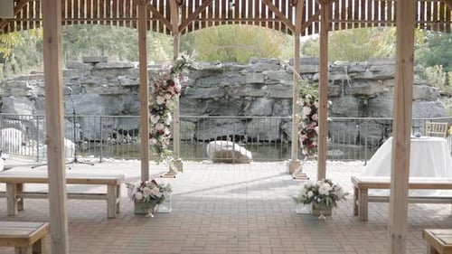 Walking down the isle of a beautiful outdoor pergola wedding venue during the fall at Orchard View W