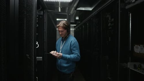 Engineers Performing Server Rack Maintenance in Data Center